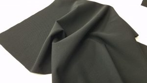 black fabric laying on white background