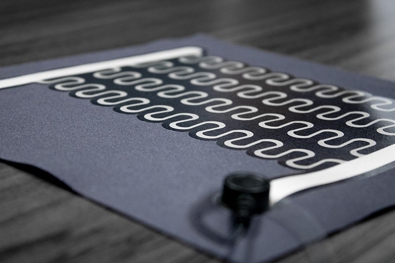 BTI Printed Heater technology on a gray wooden table background