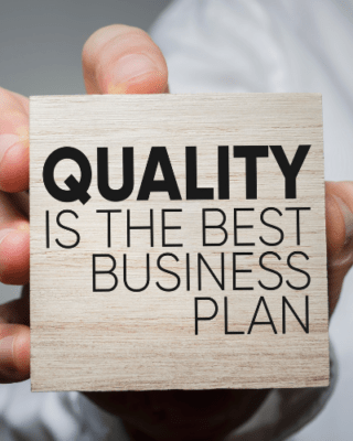 "quality is the best business plan" printed onto a square block of wood