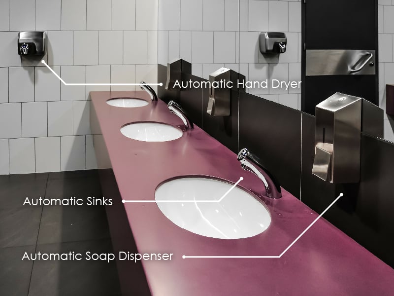 proximity sensors in a public bathroom on the hand dryer, sinks, and soap dispenser
