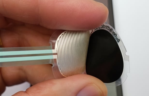 Person holding a flexible force sensing resistor