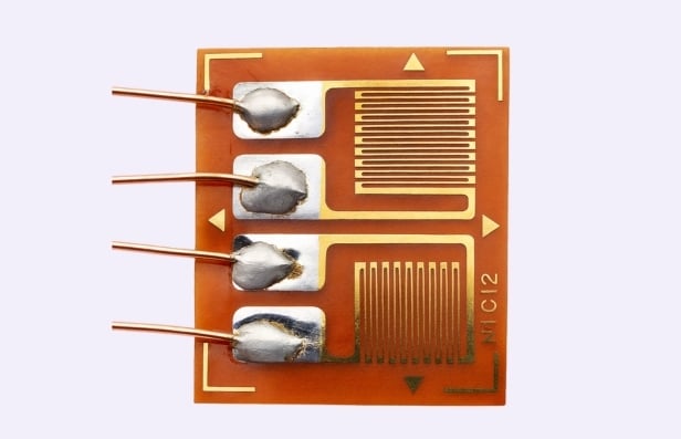Close-up of a strain gauge sensor with wires