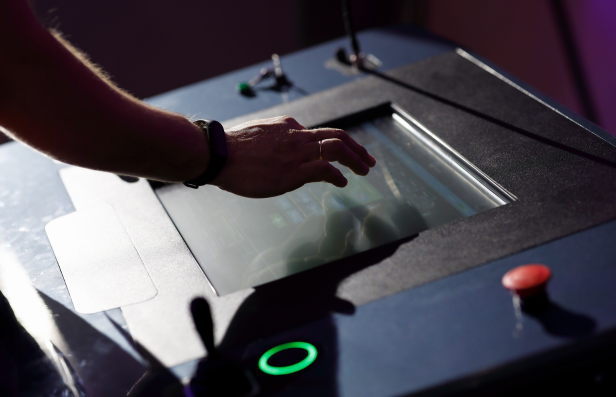Operator using a touch screen HMI on industrial equipment