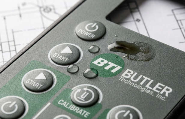 Close-up of durable industrial graphic overlay with chemical resistance demonstration